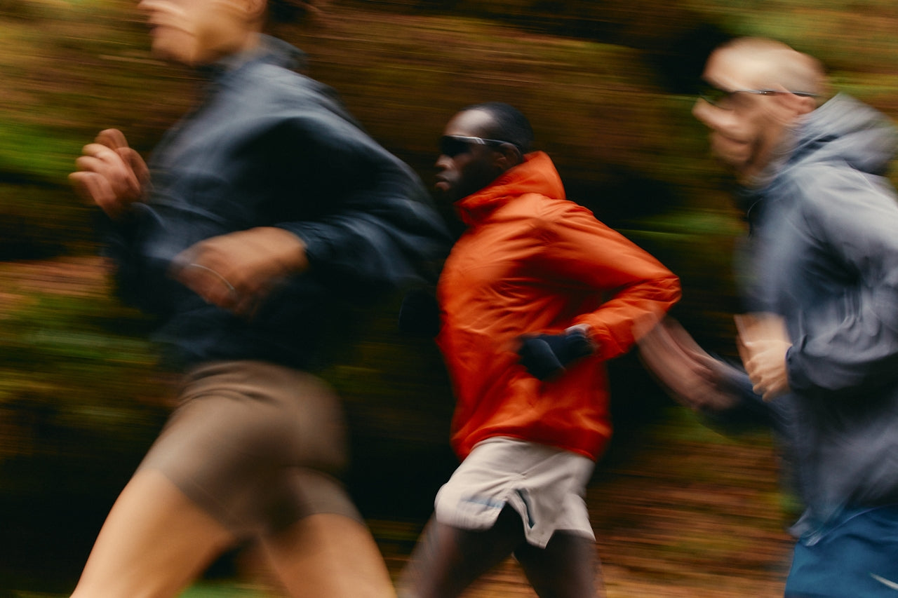 Three runners in motion with a blurred background